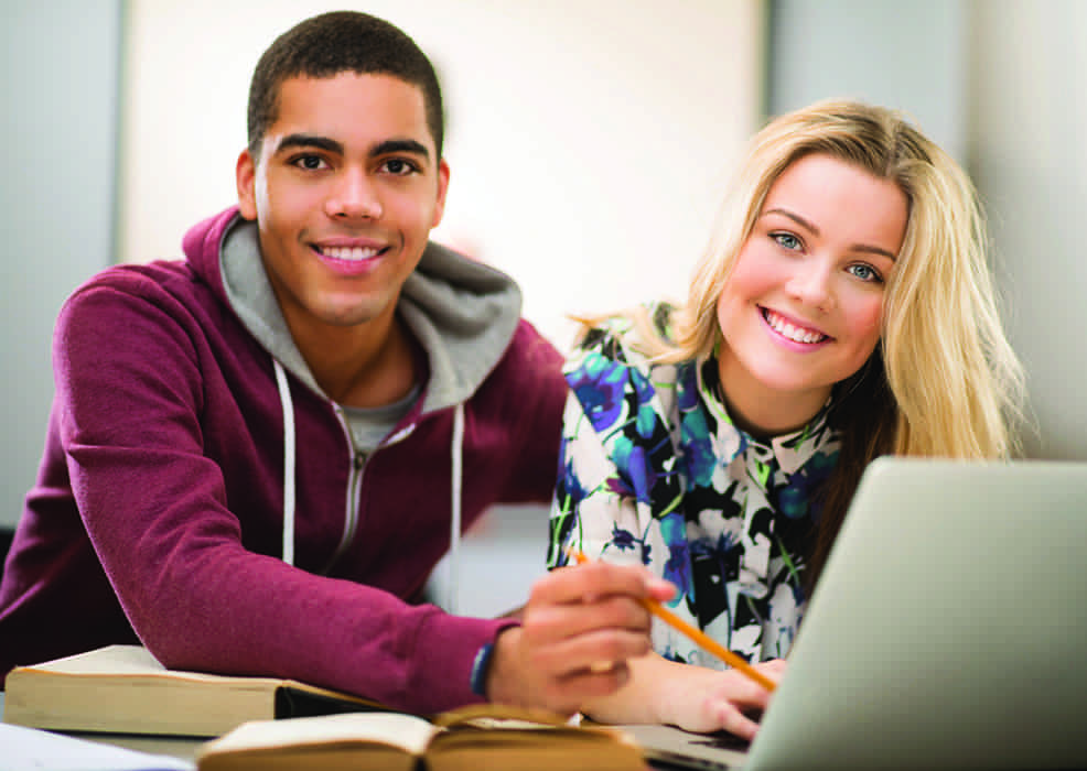 Two young people working together on a laptop